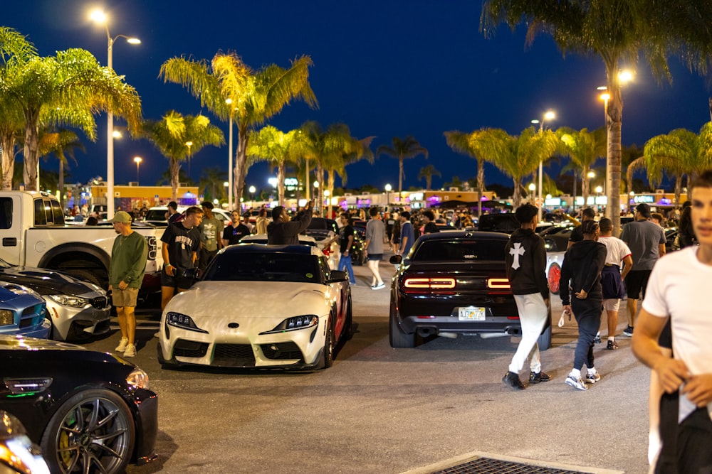 a crowd of people walking around a parking lot