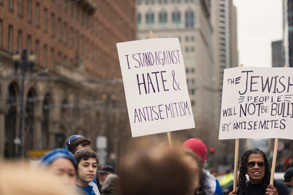 a group of people holding signs in the street