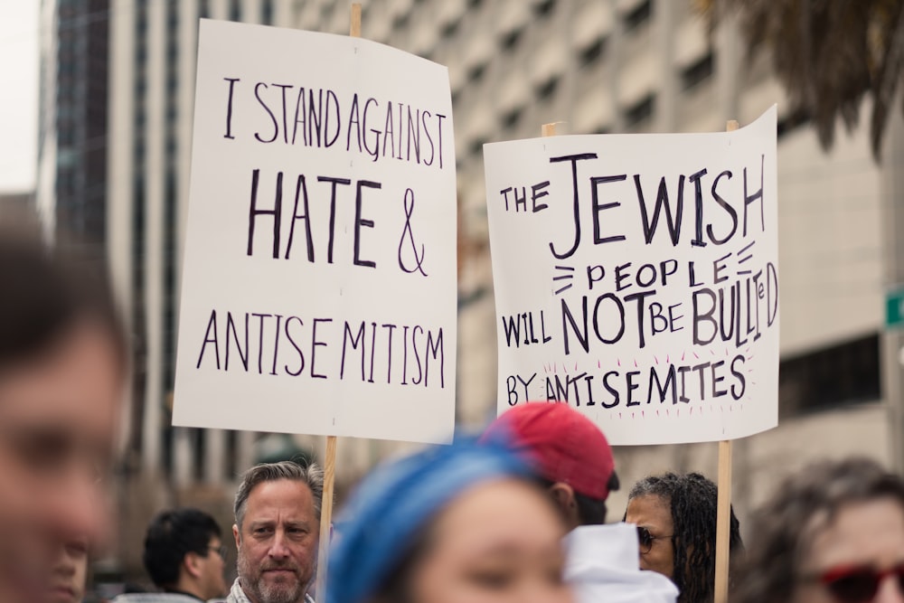 a group of people holding signs in the street