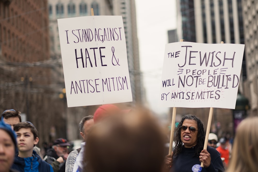 a group of people holding signs in the street