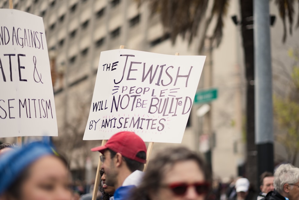 a group of people holding signs in the street