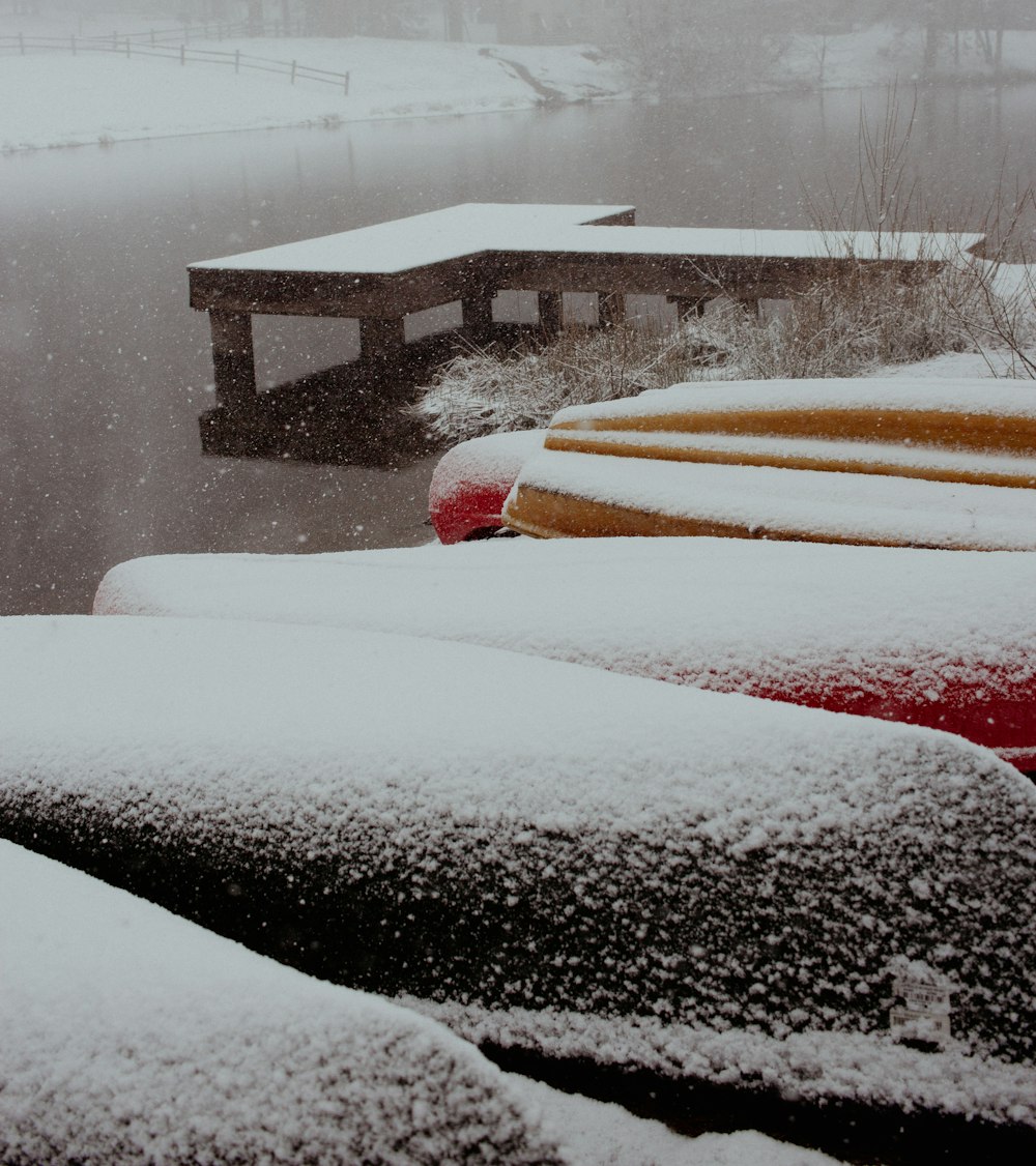 a snow covered parking lot next to a body of water