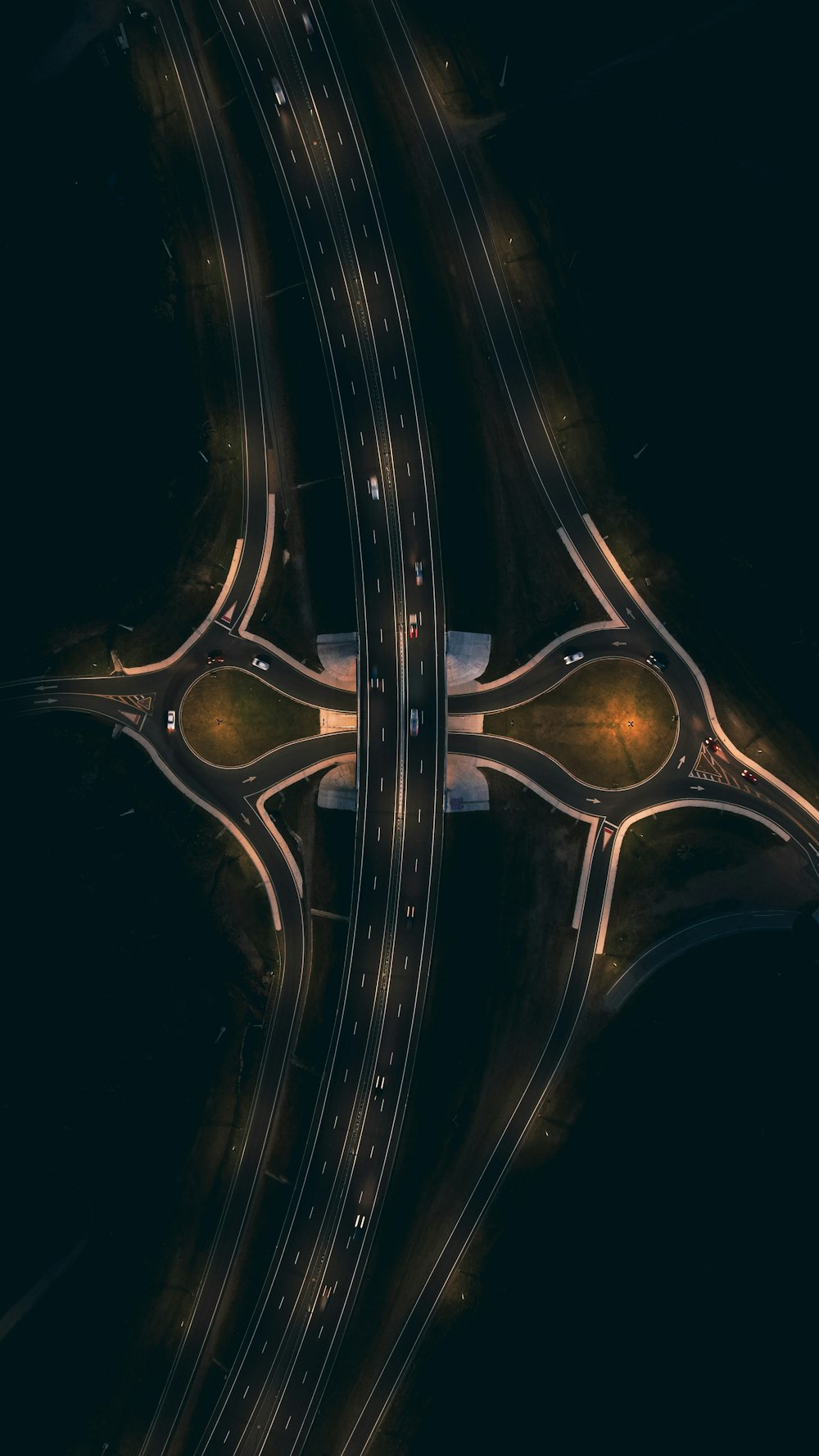 an aerial view of a highway intersection at night