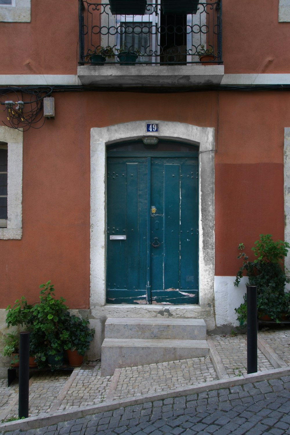 a blue door in front of a red building