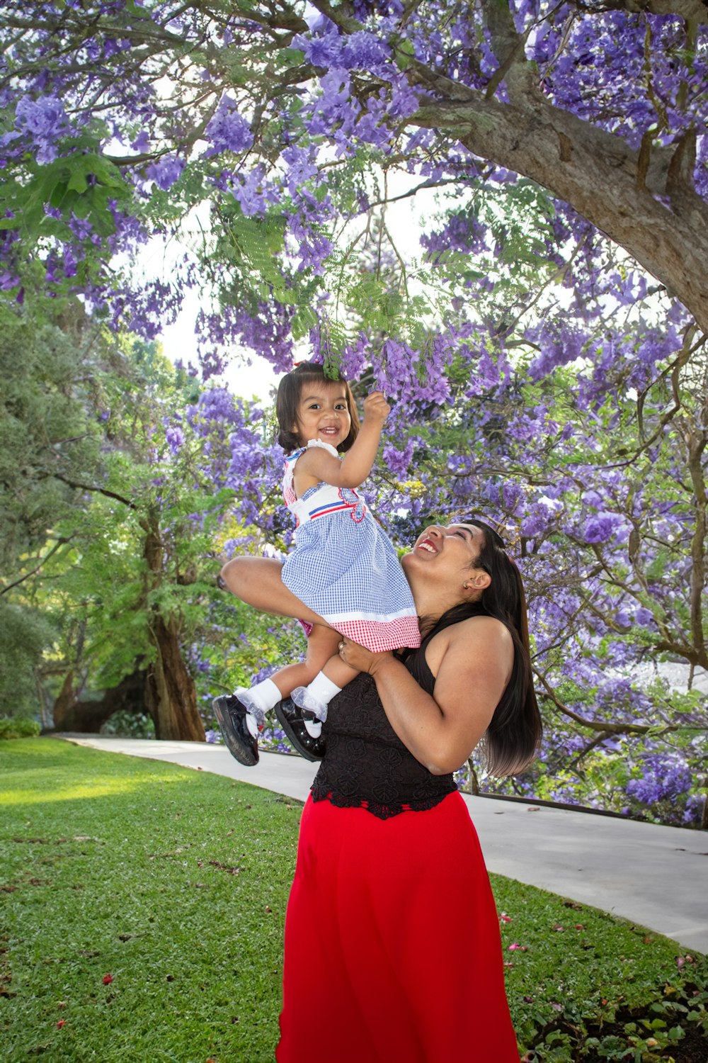 a woman holding a little girl in her arms