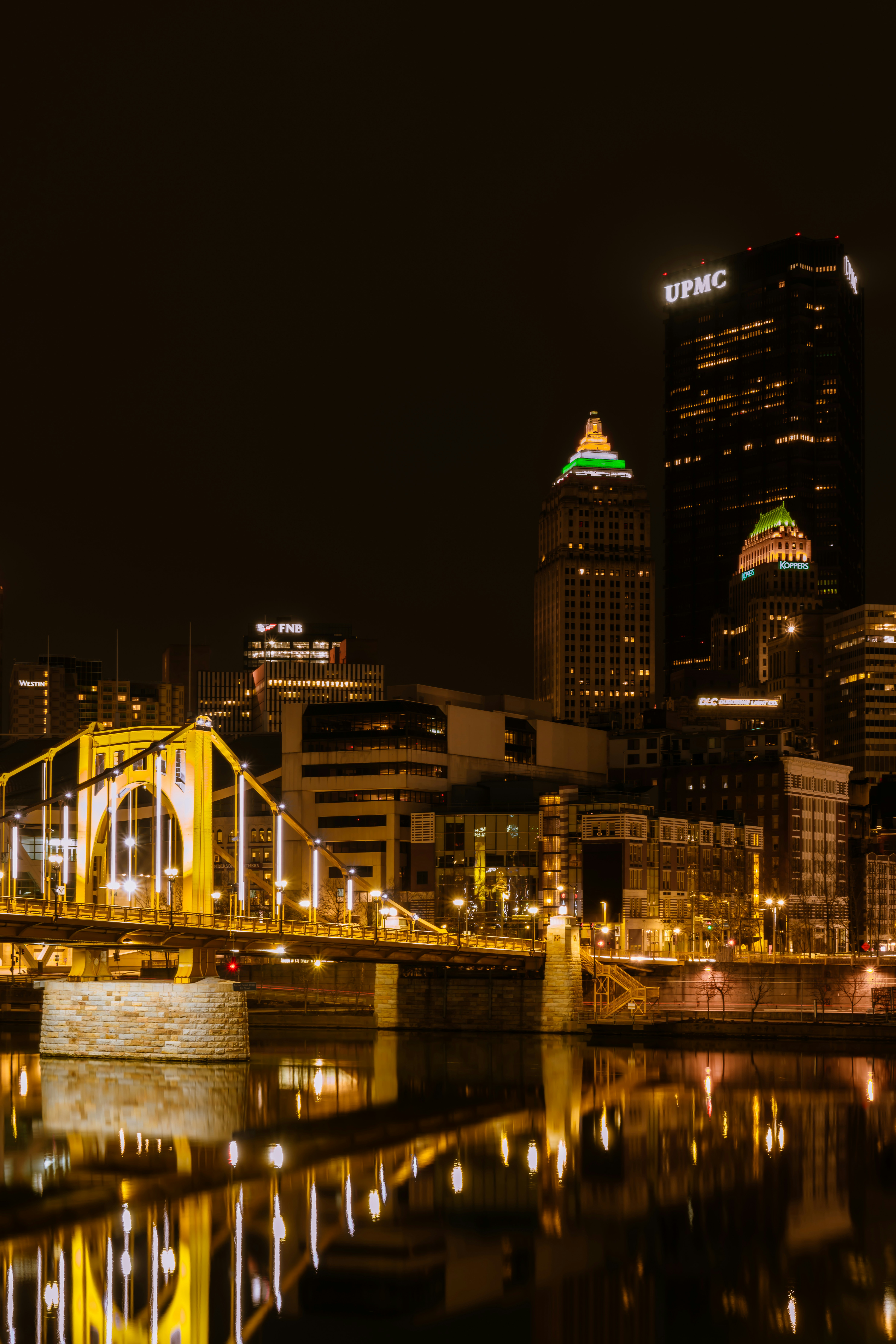 A city at night with a bridge over a body of water photo – Free City ...