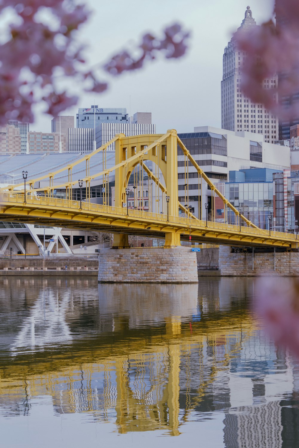 a bridge over a body of water with buildings in the background