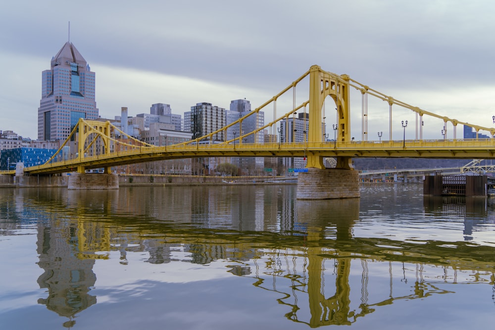 a large yellow bridge over a body of water