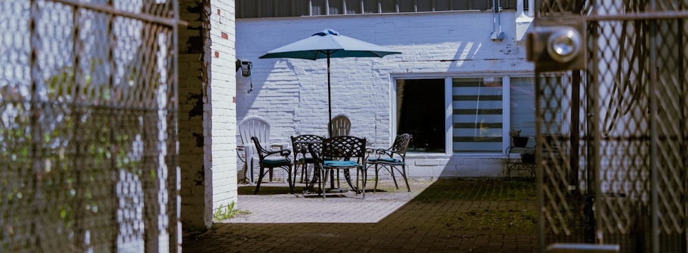 a patio with a table and chairs and an umbrella