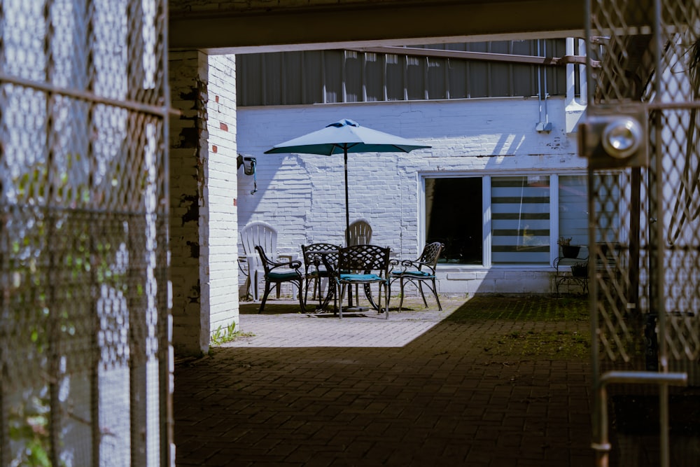 a patio with a table and chairs and an umbrella