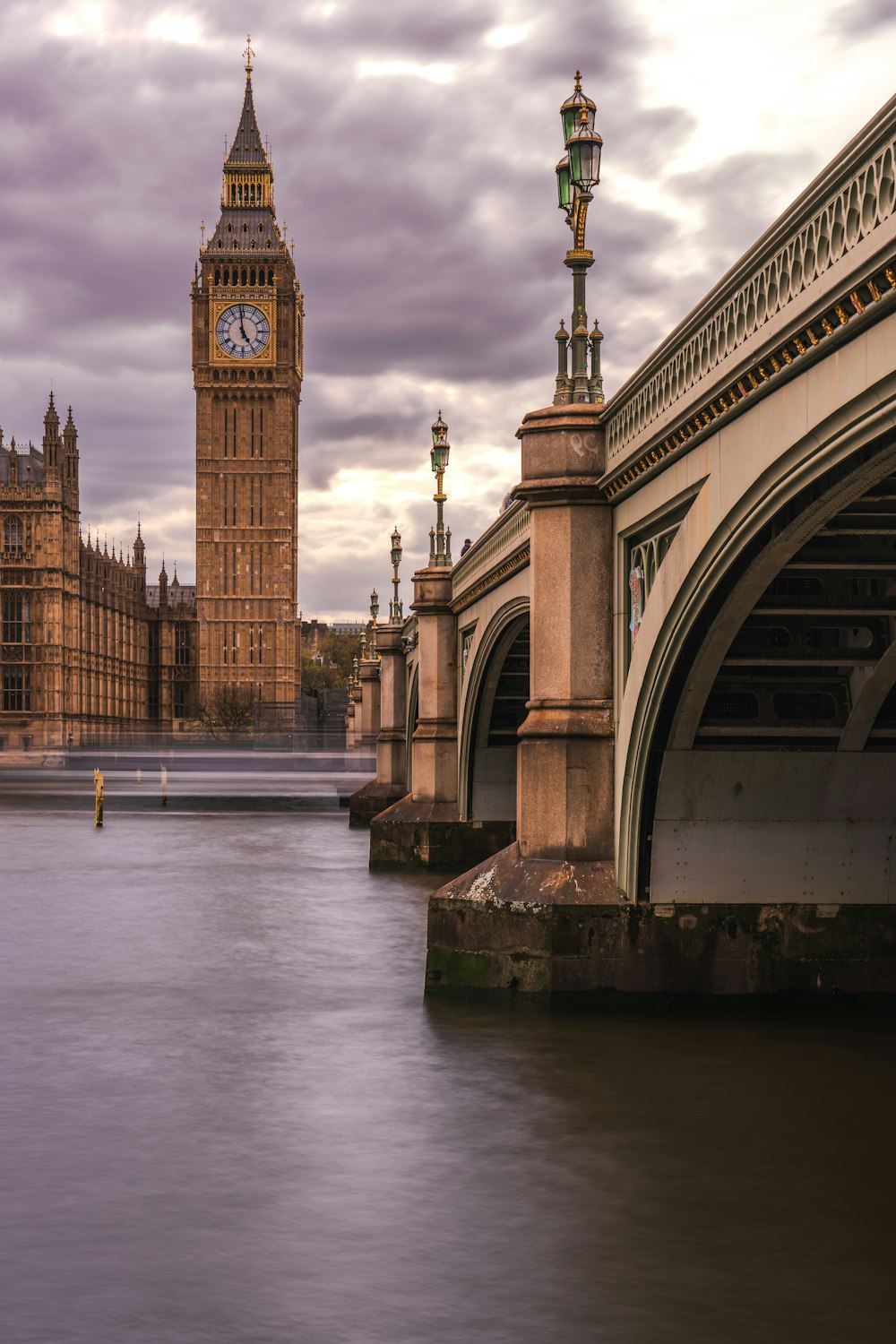 a bridge with a clock tower in the background