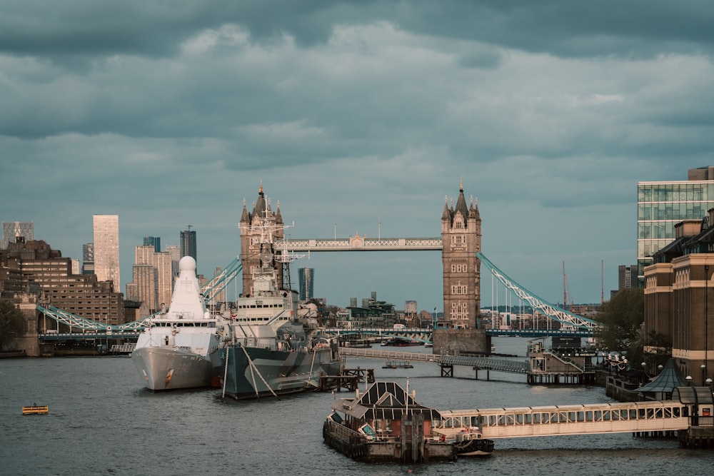 a view of a city with a bridge and a boat in the water