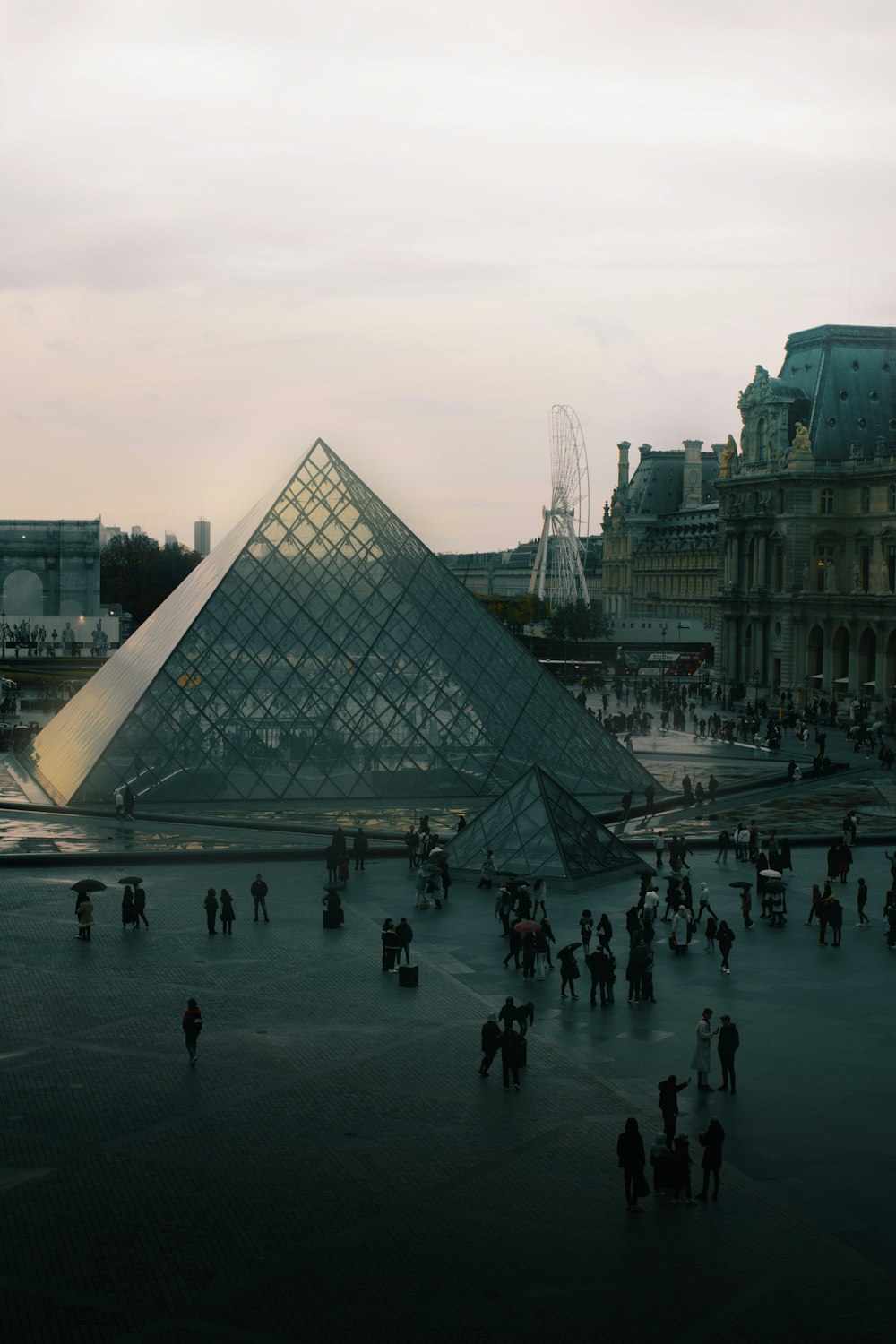 a group of people standing in front of a pyramid