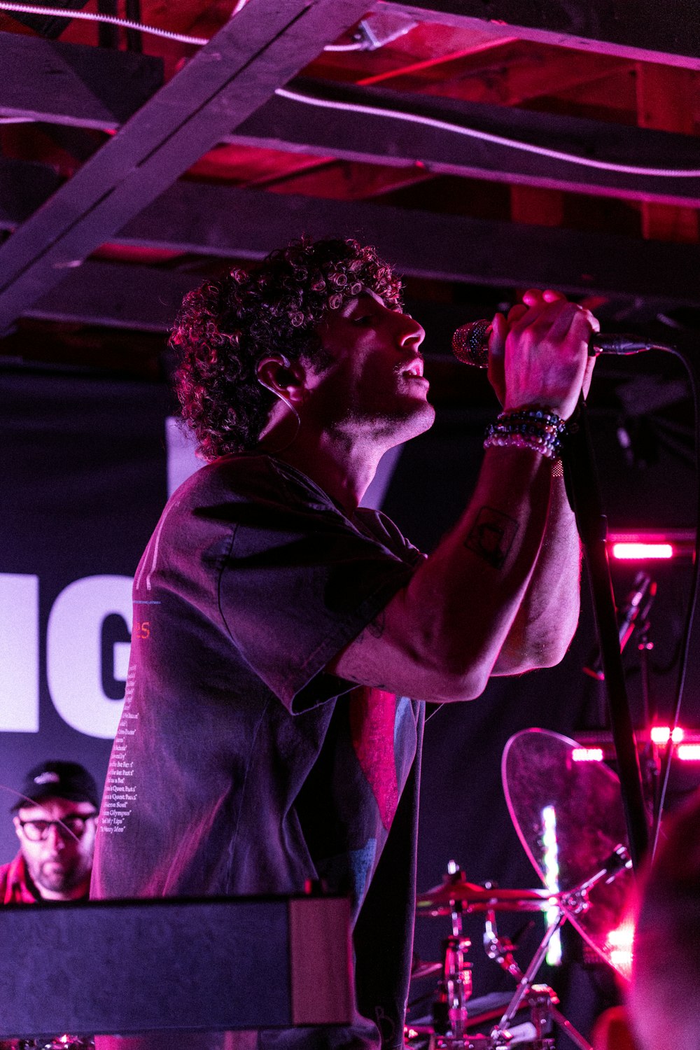 a man singing into a microphone at a concert