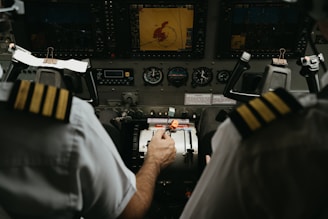 two pilots in the cockpit of a plane