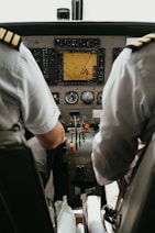 two pilots sitting in the cockpit of a plane