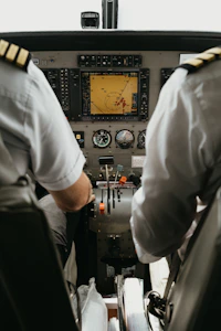 Two pilots at the flight deck controls