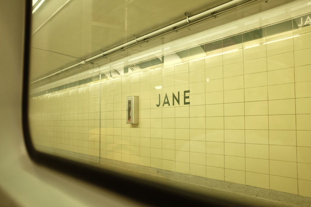 a subway station with a sign on the wall