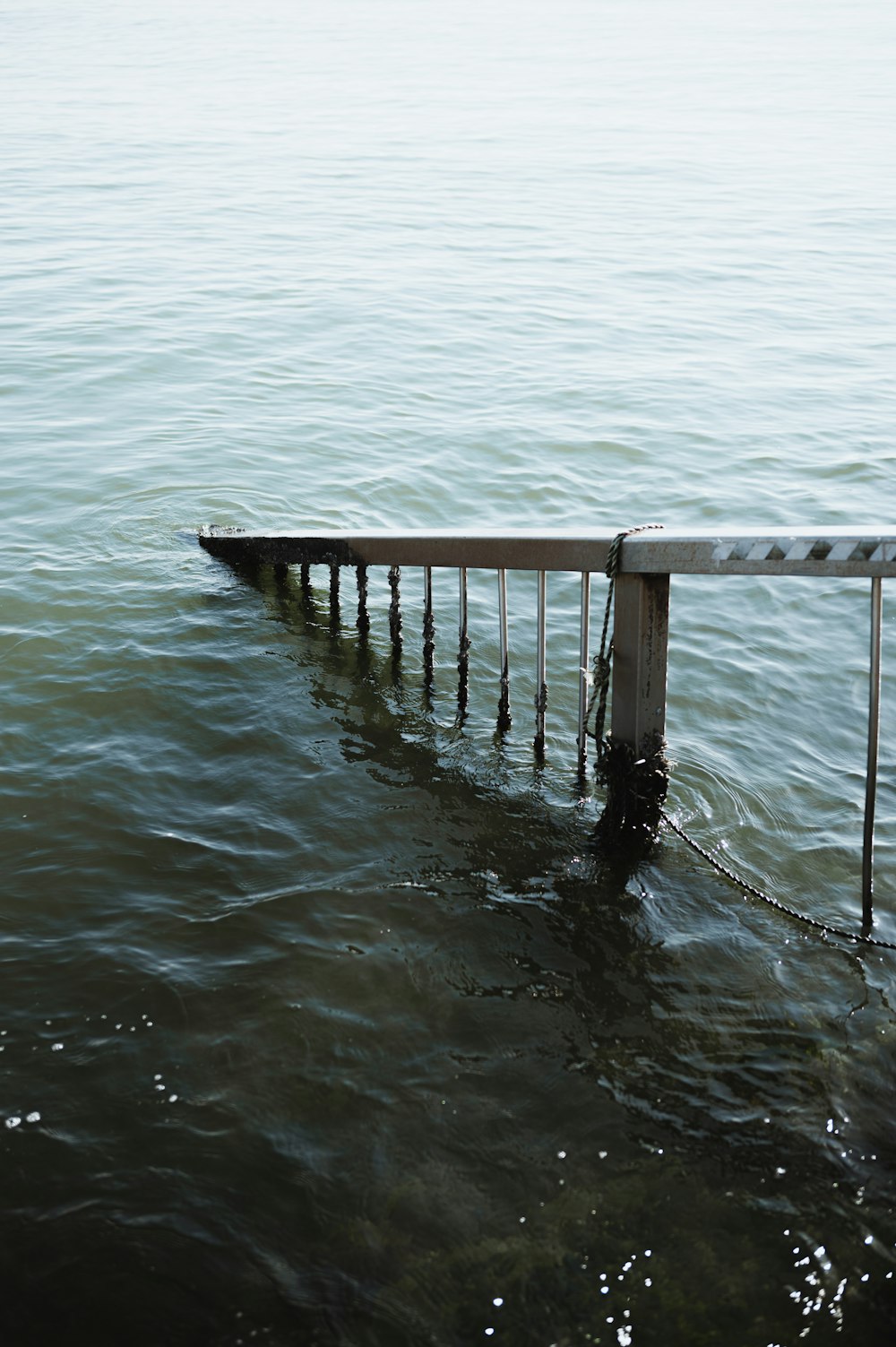 a wooden dock in the middle of a body of water