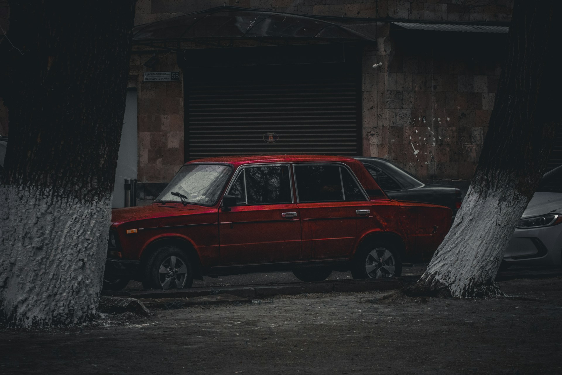 a red car parked in front of a building