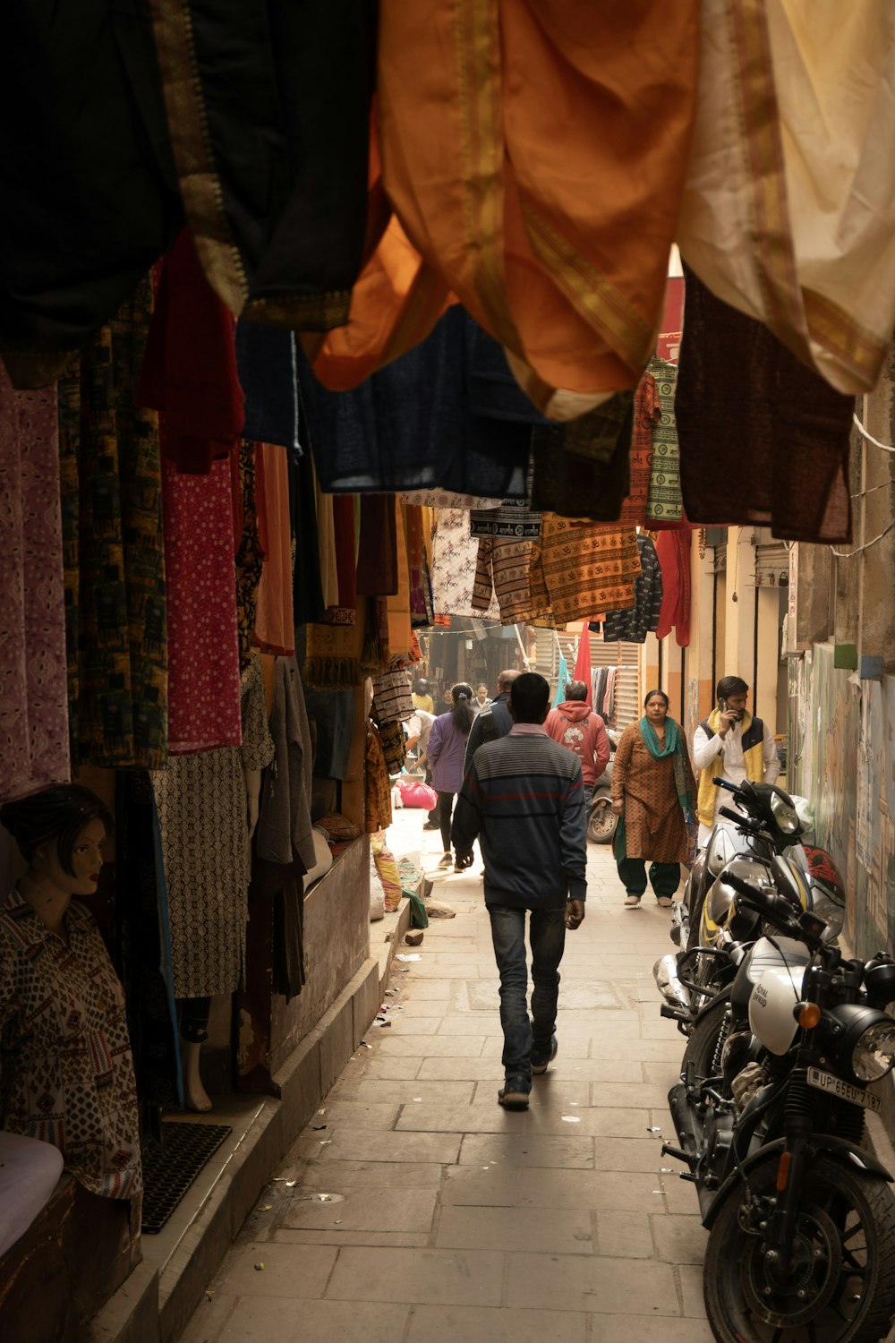 a man walking down a narrow alley way