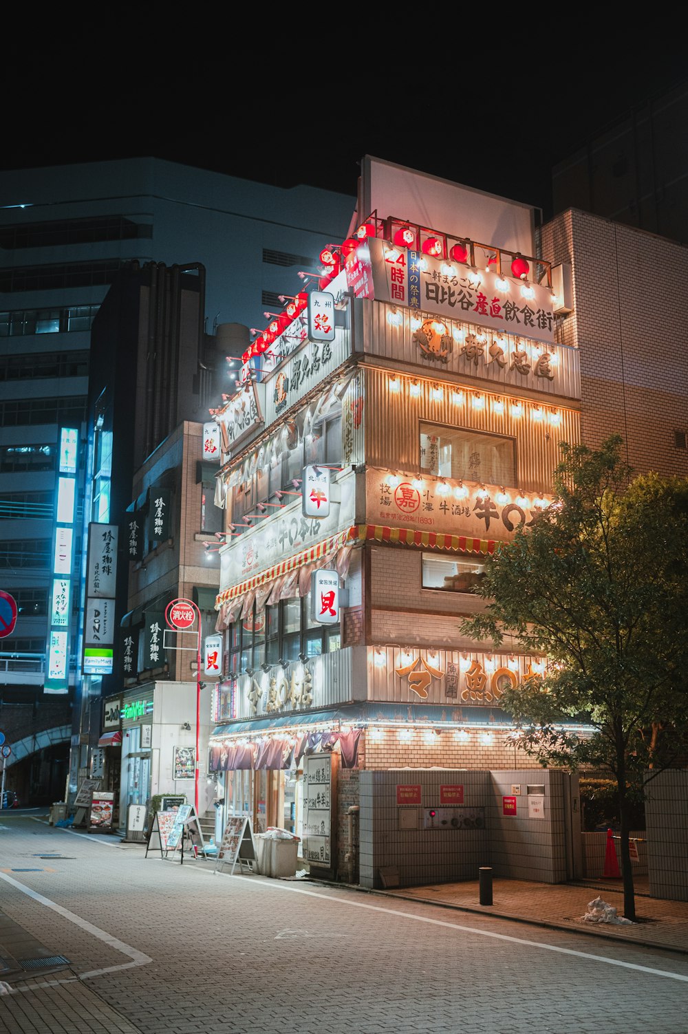 a tall building with lights on the side of it