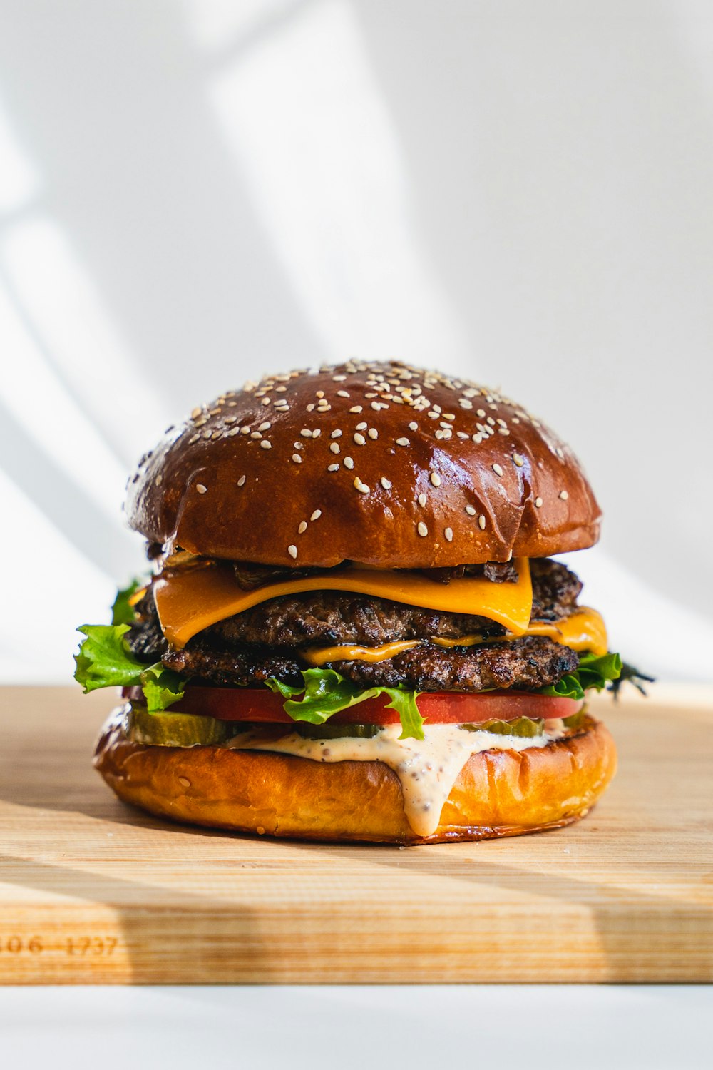 a hamburger sitting on top of a wooden cutting board