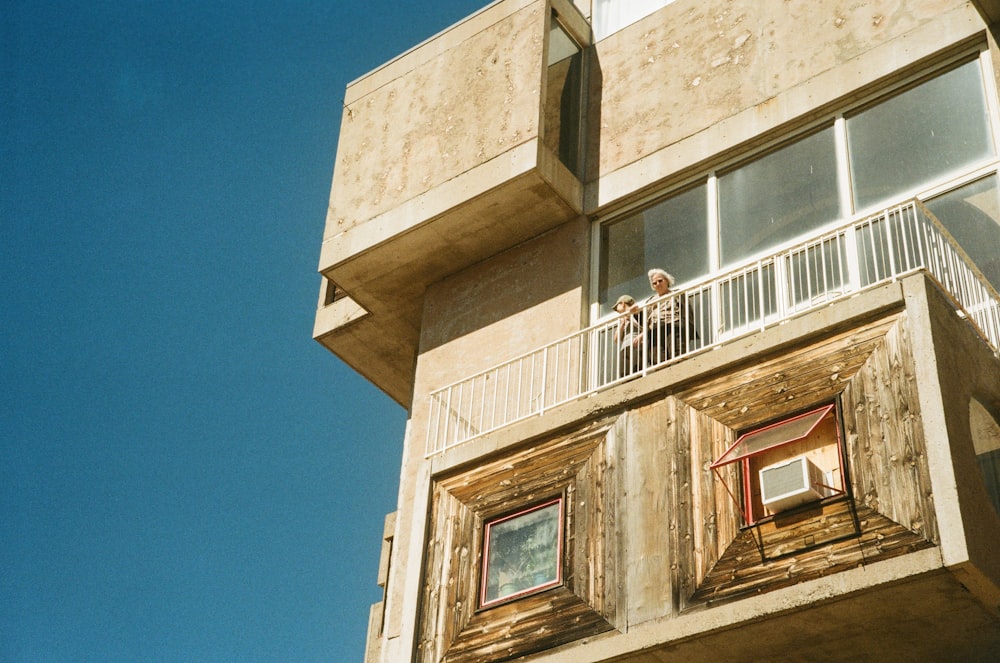 a person standing on a balcony of a building