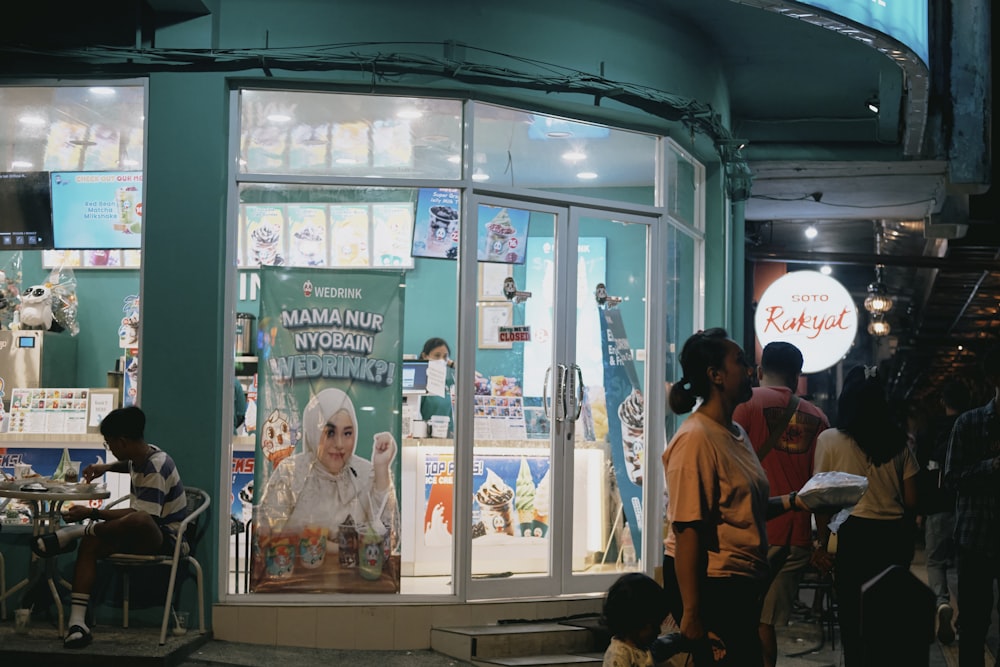 a group of people standing outside of a store