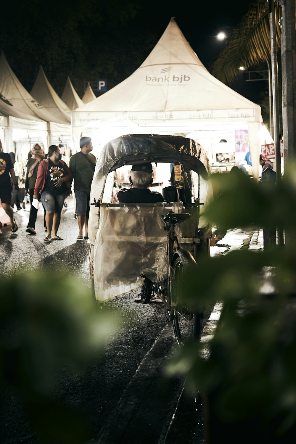 a man driving a small car down a street