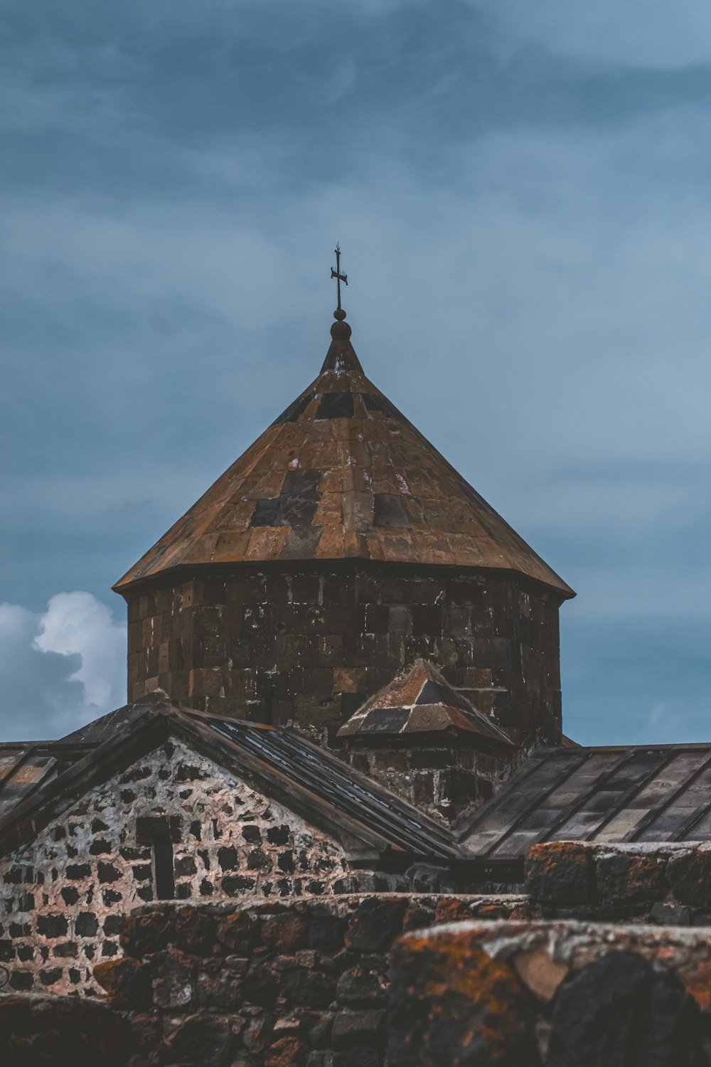 an old building with a steeple and a cross on top