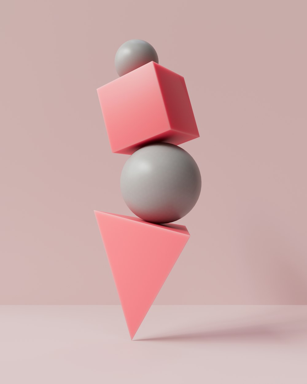 a gray and pink object with a gray ball on top of it
