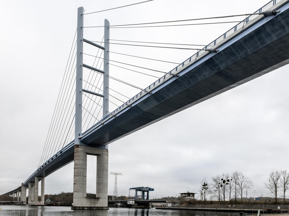 a bridge over a body of water on a cloudy day