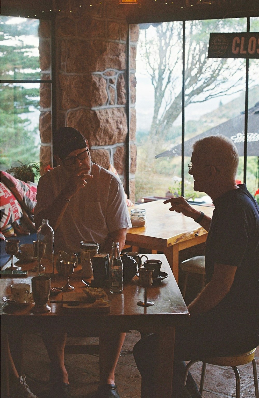 a group of people sitting around a wooden table