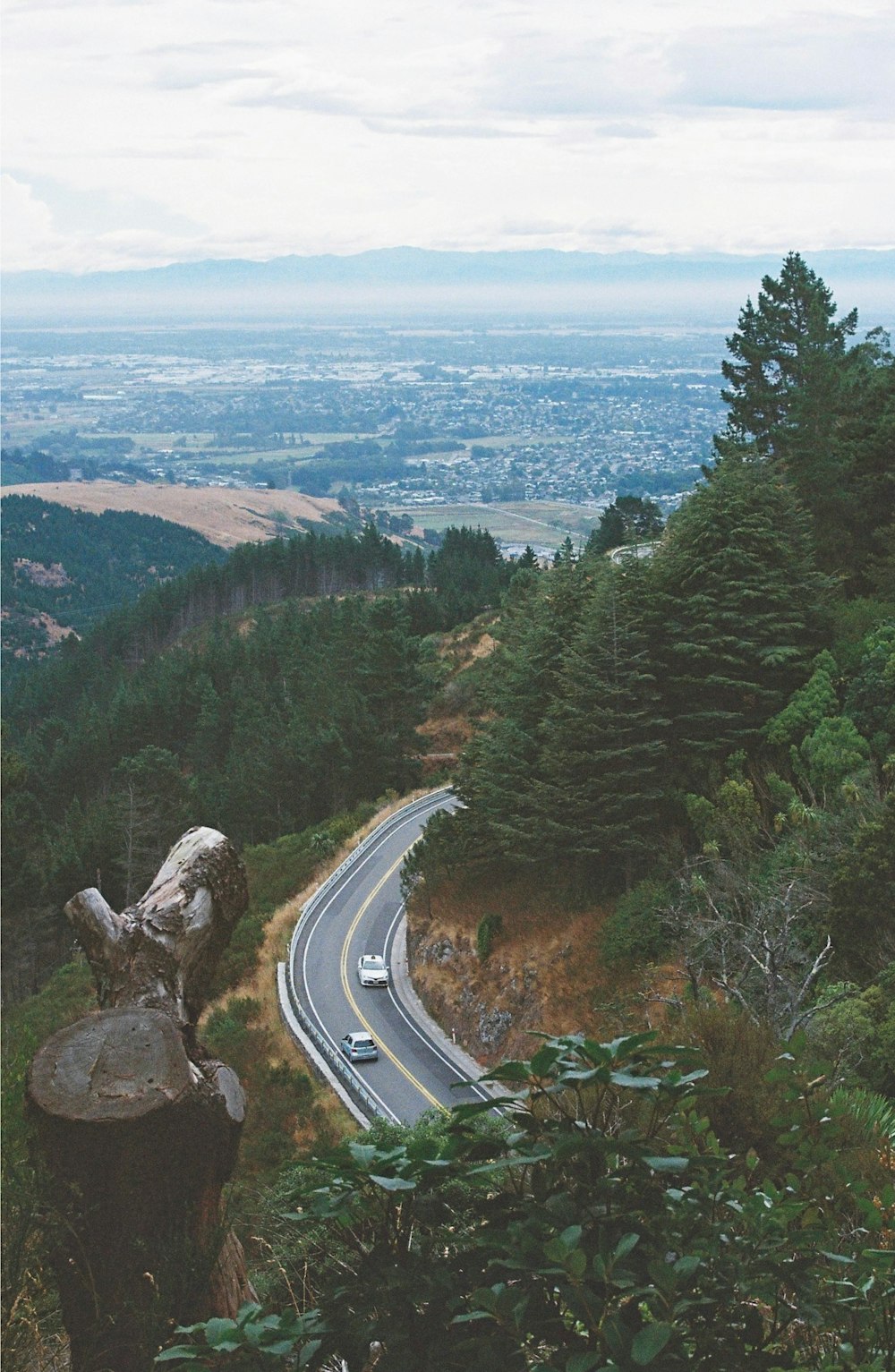 a car driving down a winding road in the mountains