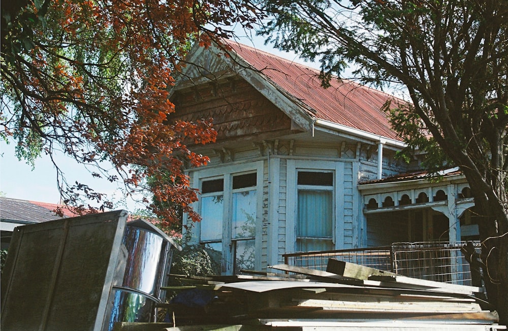 a house with a red roof and a tree in front of it