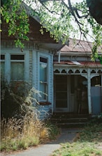 an old run down house with a broken door