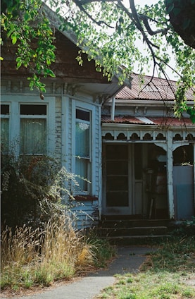 an old run down house with a broken door
