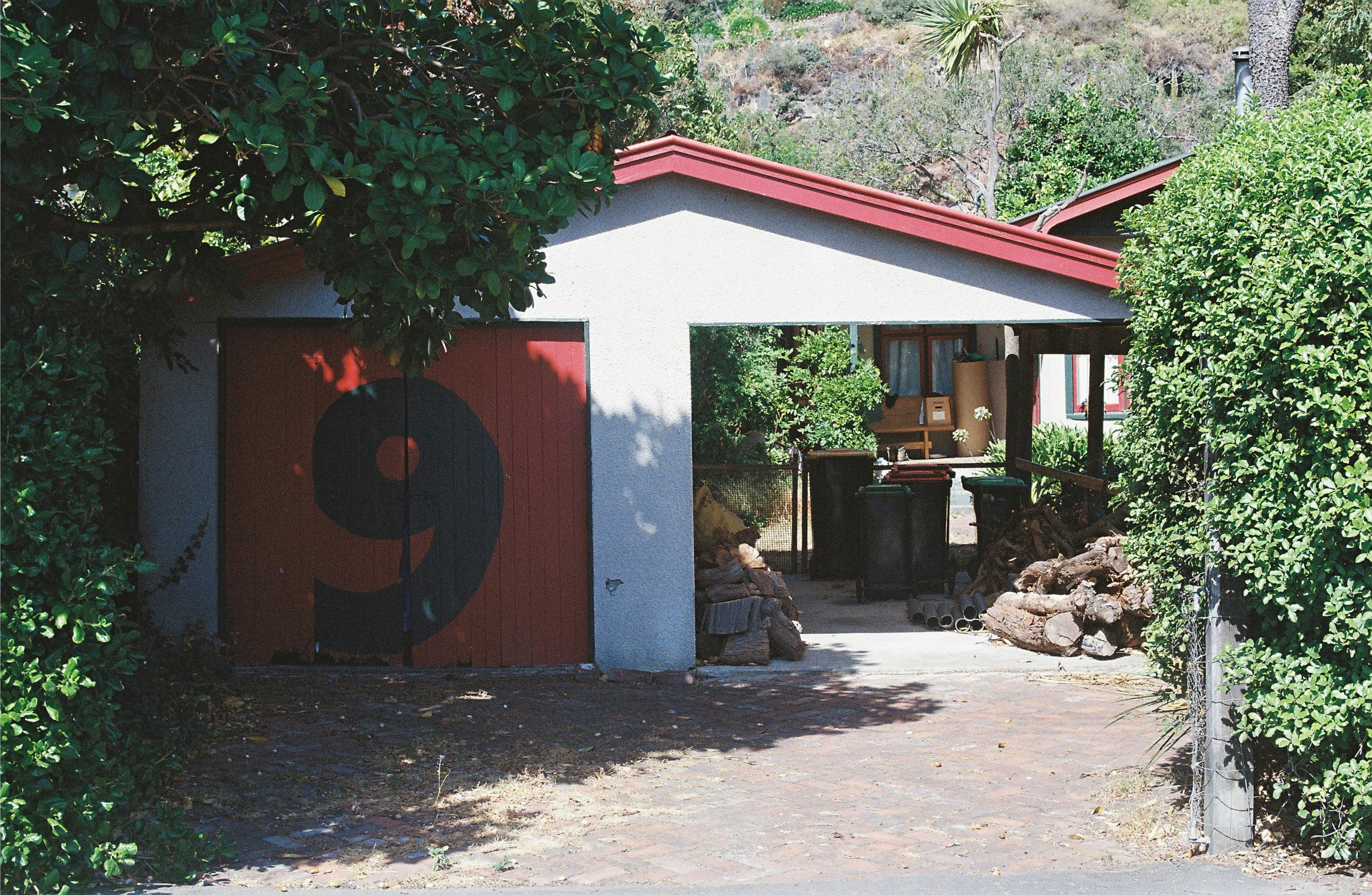 a red and white garage with a number 9 painted on it