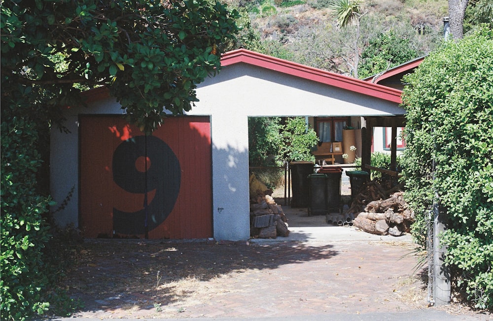 a red and white garage with a number 9 painted on it