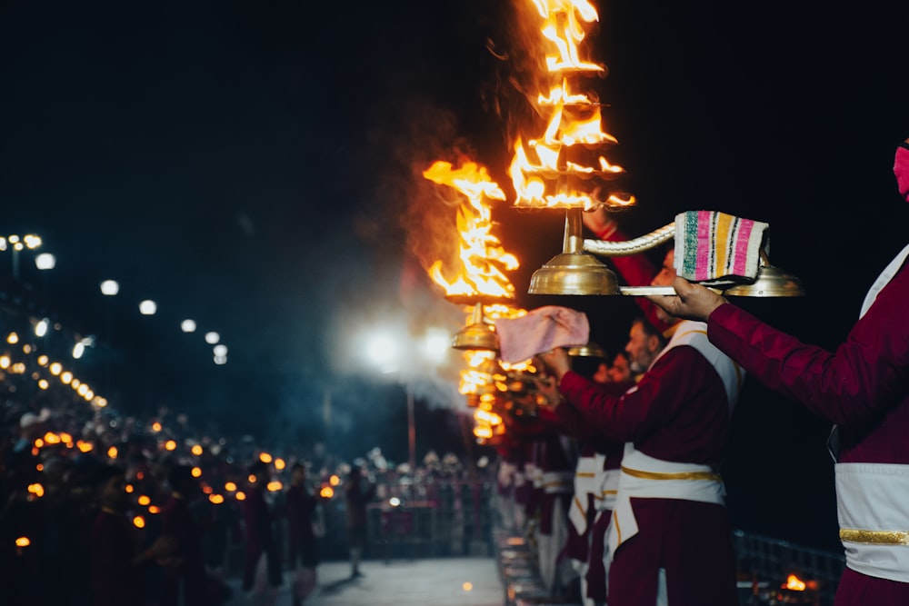 a group of people standing around a fire