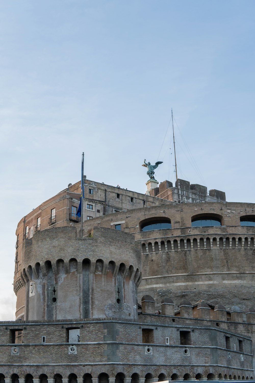 a large building with a statue on top of it