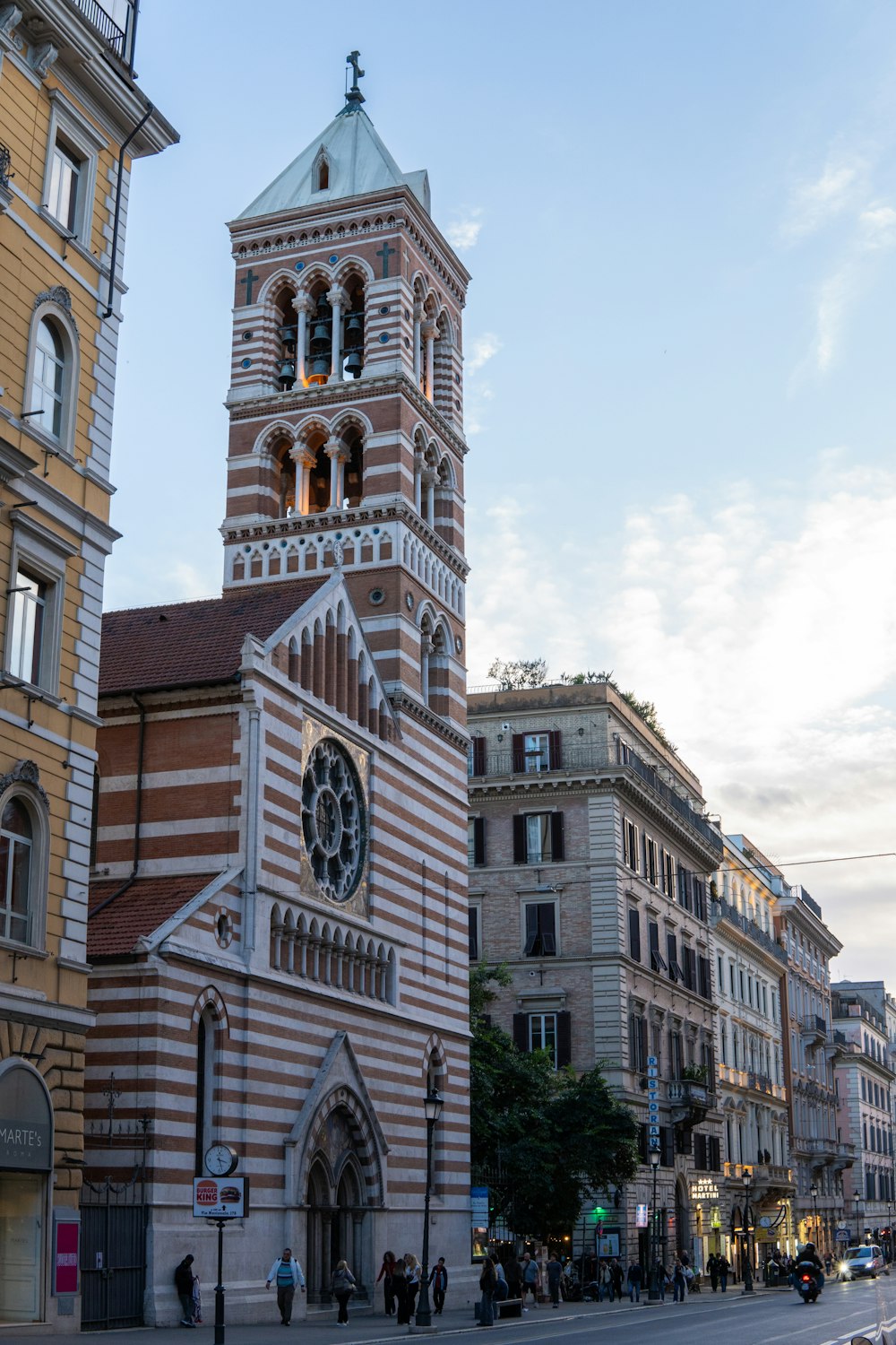 a tall brick building with a clock on it's side