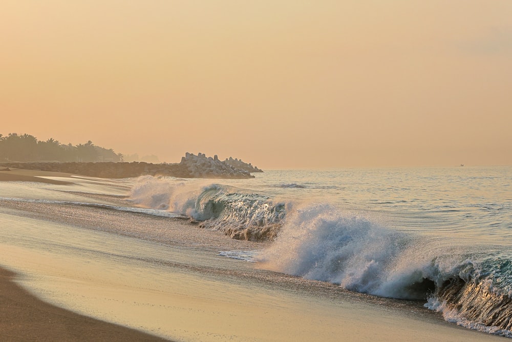 a beach with waves crashing into the shore