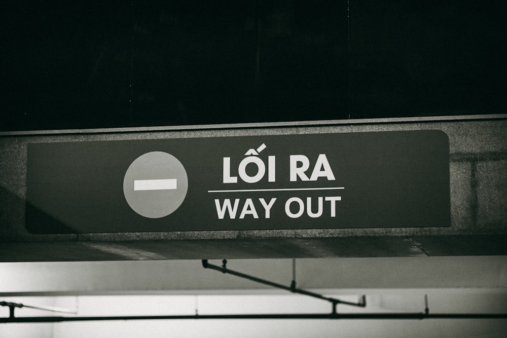 Ein Schwarz-Weiß-Foto eines Schildes mit der Aufschrift "Loi Ra Way Out"