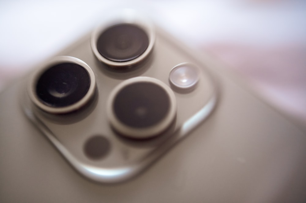 a close up of a four button game controller