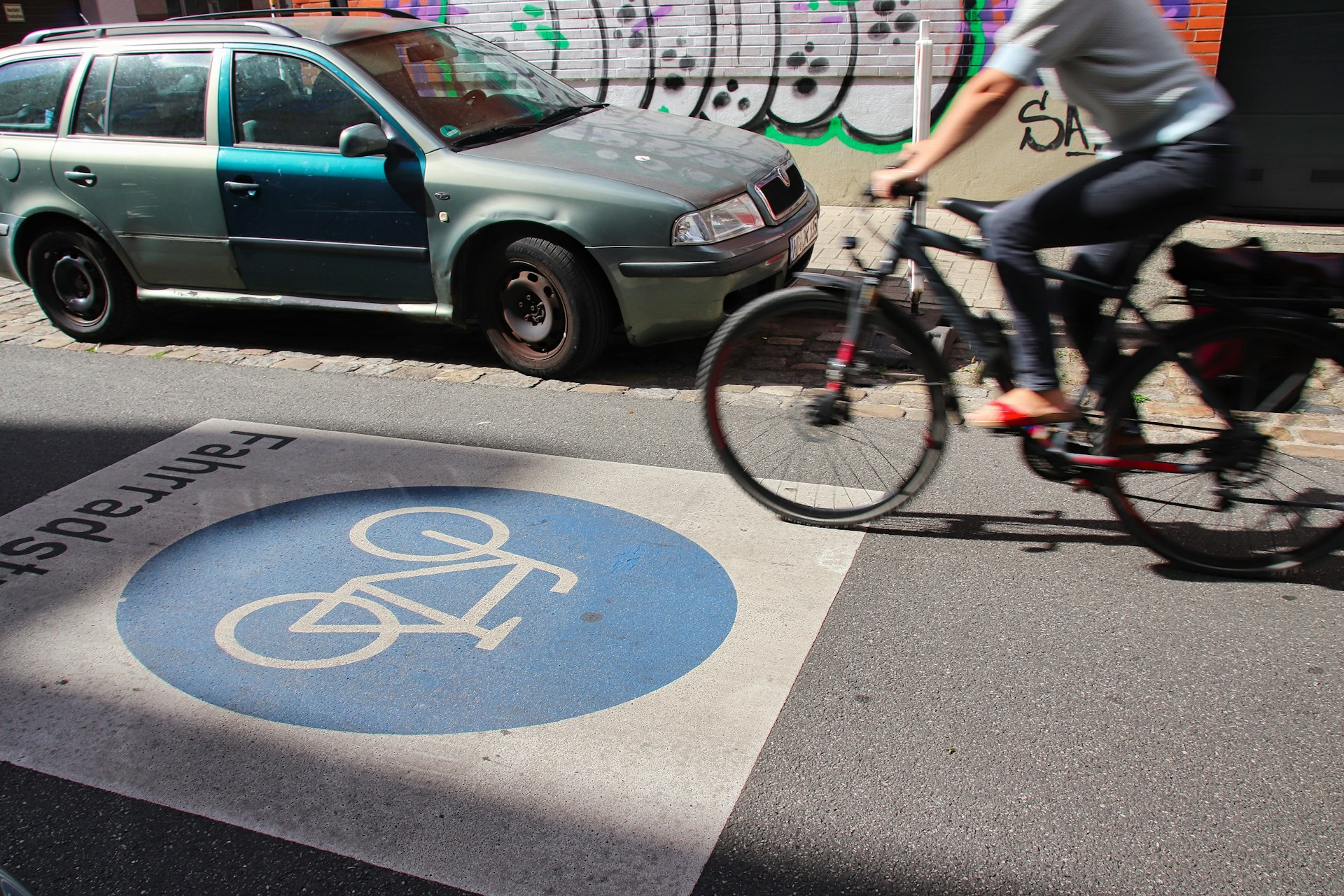 a person riding a bike on a city street