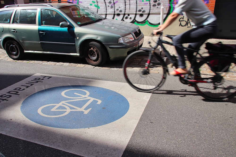 a person riding a bike on a city street