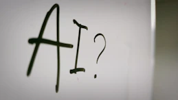 a sign with a question mark and a question mark drawn on it