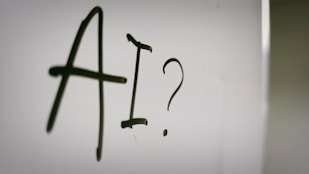 a sign with a question mark and a question mark drawn on it